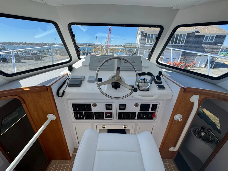 Slide: The Image of Helm of 2020 Cape Powercat 3500 PH with modern controls and panoramic windows. - 20