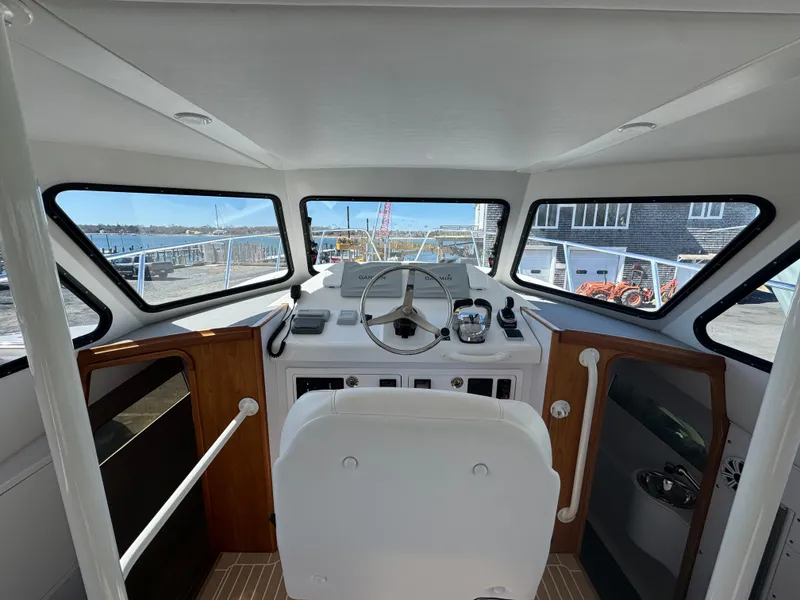 Slide: The Image of Interior helm of 2020 Cape Powercat 3500 PH with panoramic windows and modern controls. - 21