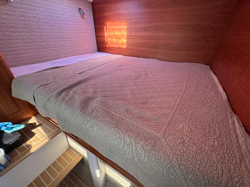 Slide: The Image of Cozy cabin interior of 2020 Cape Powercat 3500 PH with a neatly made bed. - 25
