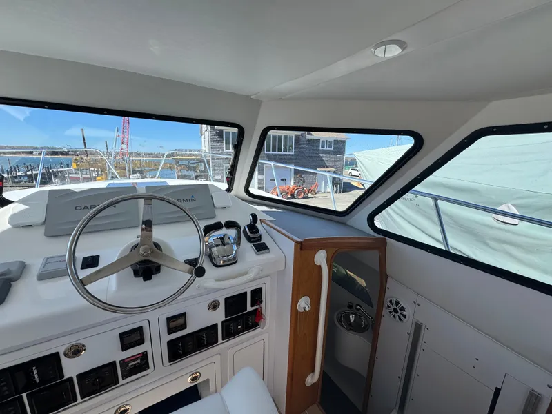 Slide: The Image of Interior view of 2020 Cape Powercat 3500 PH boat cockpit with steering wheel and controls. - 26