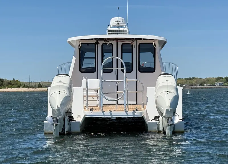 Slide: The Image of Cape Powercat 3500 PH 2020 model boat anchored on water under clear blue sky. - 3