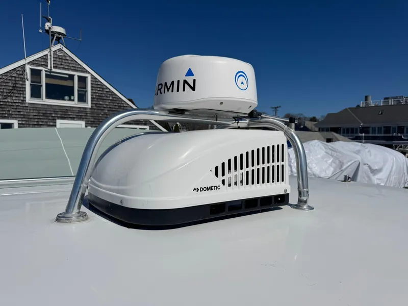 Slide: The Image of Garmin and Dometic equipment on 2020 Cape Powercat 3500 PH boat roof under clear blue sky. - 30