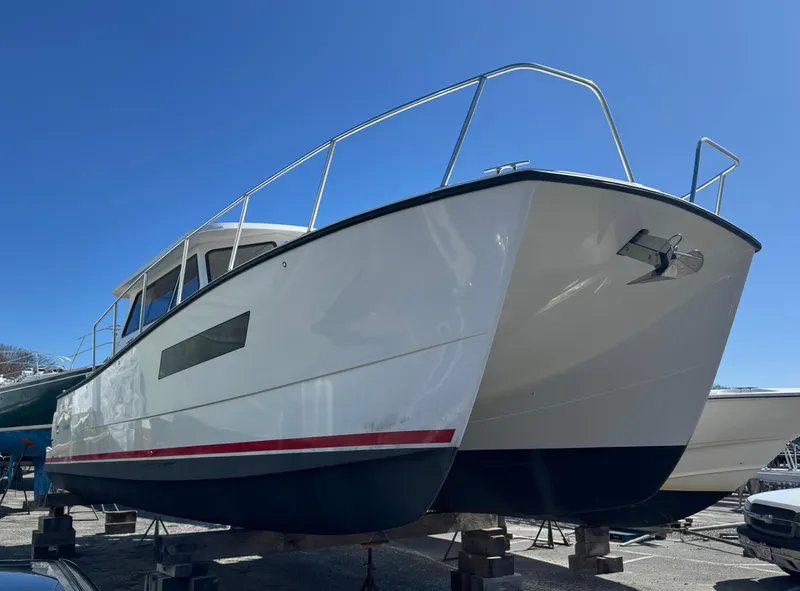Slide: The Image of 2020 Cape Powercat 3500 PH boat on stands under clear blue sky. - 8