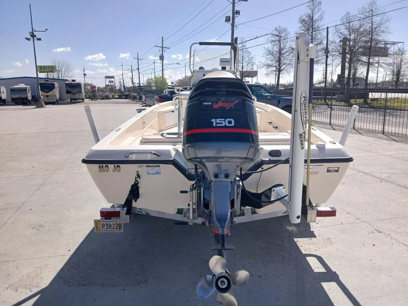 Slide: The Image of 2010 Skeeter 20 ZX boat with 150 HP engine, parked outdoors. - 10