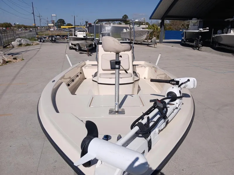Slide: The Image of 2010 Skeeter 20 ZX boat with trolling motor, parked outdoors on concrete. - 11