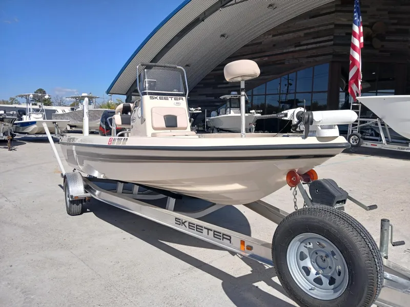 Slide: The Image of 2010 Skeeter 20 ZX boat on trailer, parked outdoors near a building. - 12
