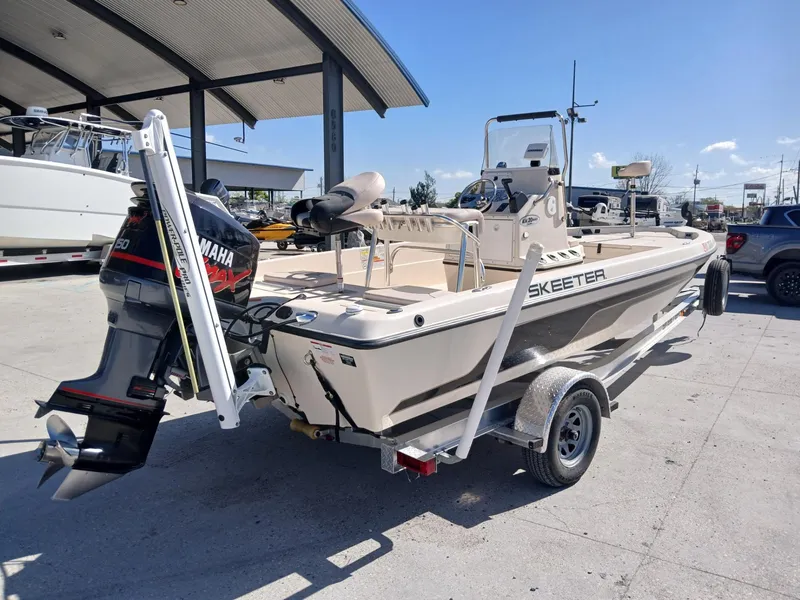 Slide: The Image of 2010 Skeeter 20 ZX boat with Yamaha outboard motor on trailer, parked outdoors. - 16