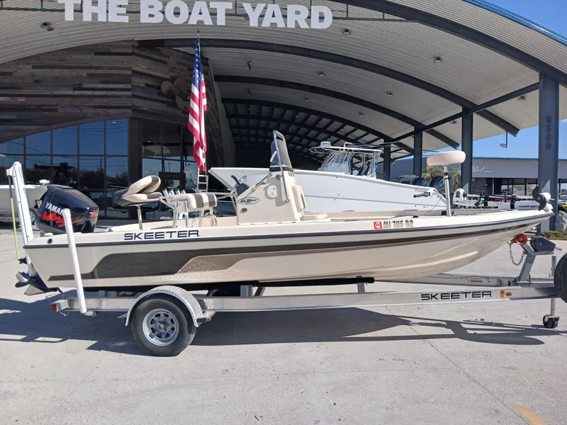 Slide: The Image of 2010 Skeeter 20 ZX boat on trailer at dealership, featuring Yamaha outboard motor. - 17