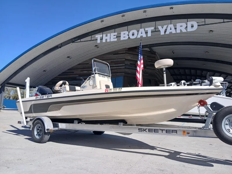 Slide: The Image of 2010 Skeeter 20 ZX boat on trailer at The Boat Yard, American flag displayed. - 18