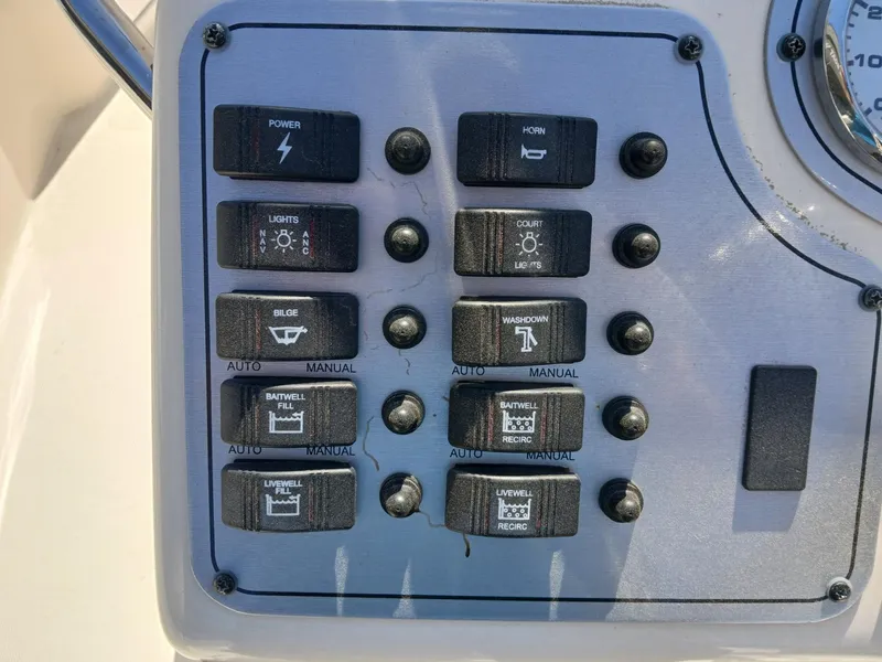 Slide: The Image of Control panel of a 2010 Skeeter 20 ZX boat with various switches. - 3