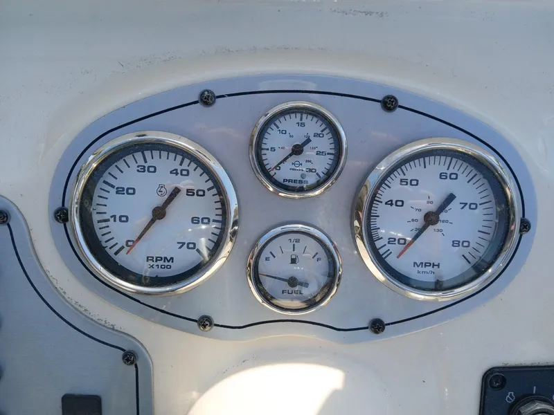 Slide: The Image of Dashboard gauges of a 2010 Skeeter 20 ZX boat, displaying RPM, speed, and fuel levels. - 4