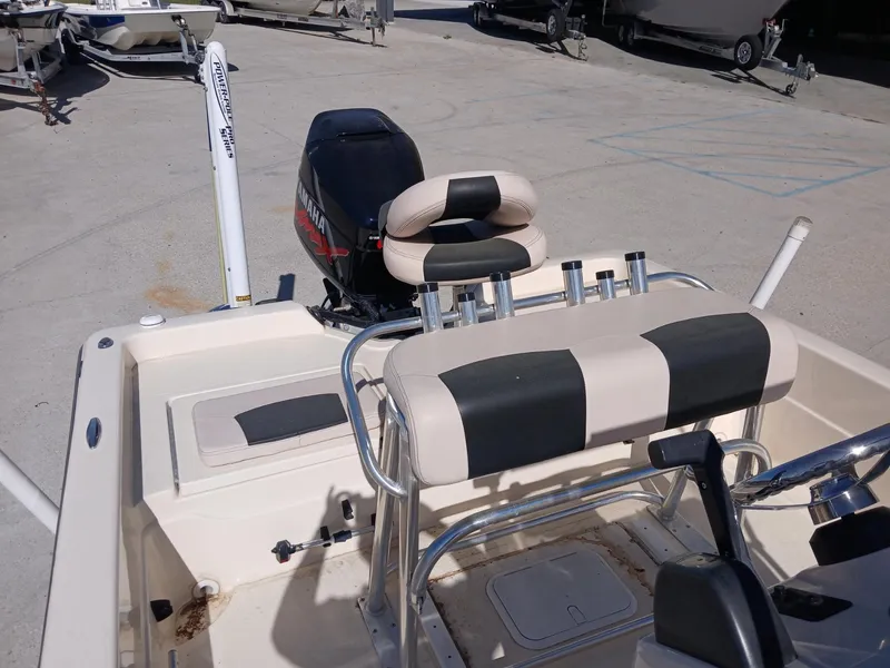 Slide: The Image of 2010 Skeeter 20 ZX boat interior with seating and motor, parked on concrete. - 6