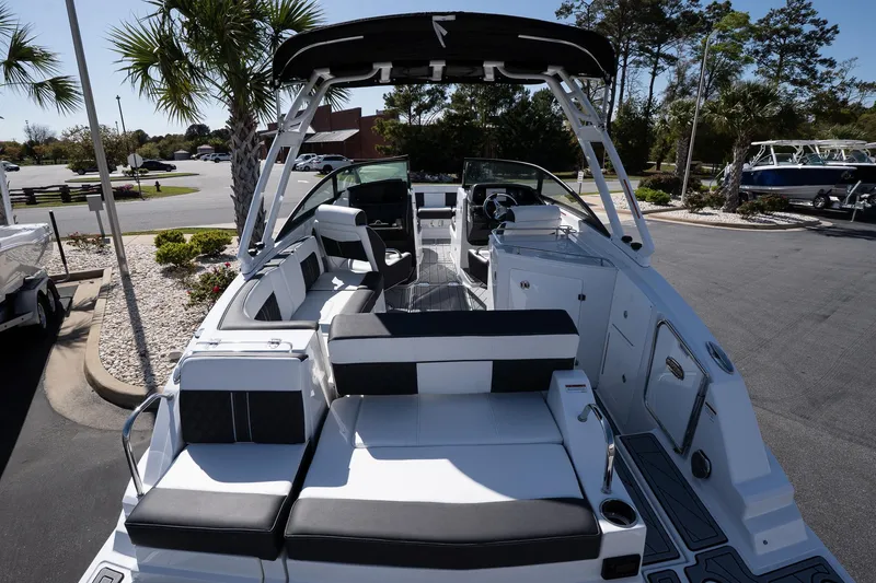 Slide: The Image of 2025 Monterey M-65 boat with sleek seating and modern design in a sunny outdoor setting. - 10