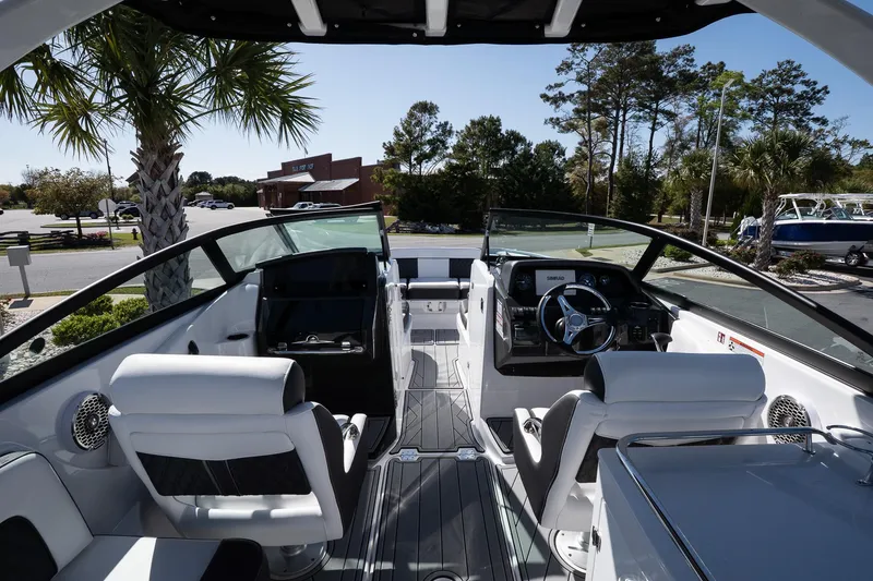 Slide: The Image of Interior view of 2025 Monterey M-65 boat with modern seating and steering wheel. - 12