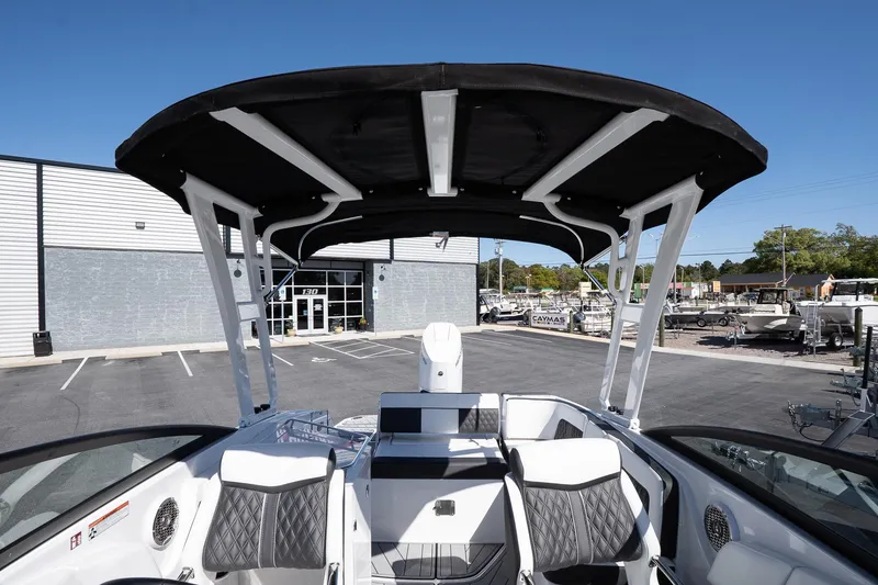 Slide: The Image of 2025 Monterey M-65 boat interior with black canopy and modern seating. - 25