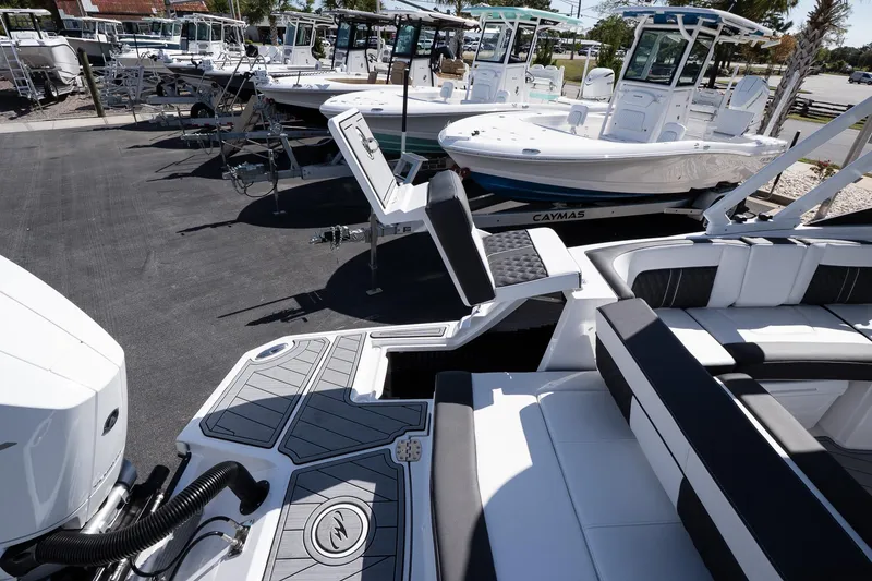 Slide: The Image of 2025 Monterey M-65 boat with sleek design, docked alongside other vessels in a marina. - 28