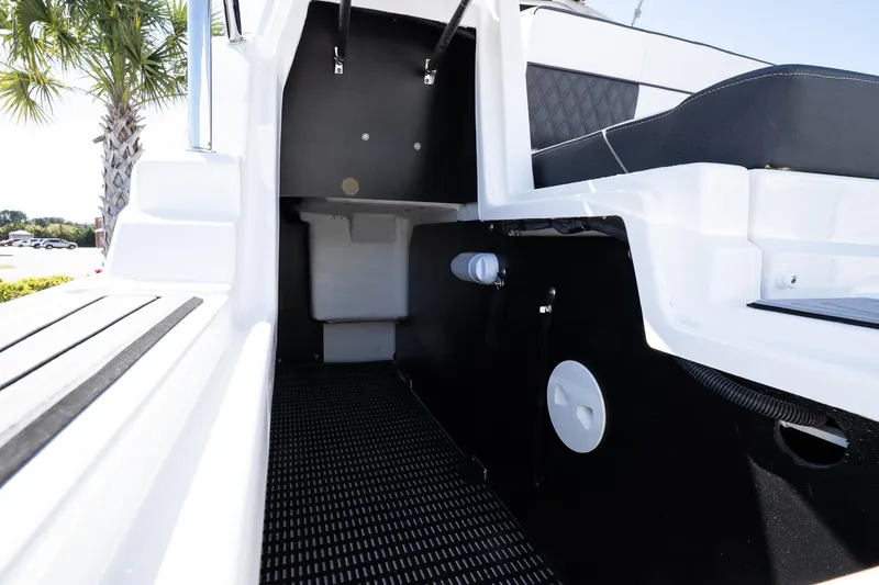 Slide: The Image of 2025 Monterey M-65 boat interior, featuring sleek black and white design with modern seating. - 29