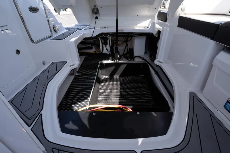 Slide: The Image of 2025 Monterey M-65 boat interior, showcasing storage compartment and seating area. - 32
