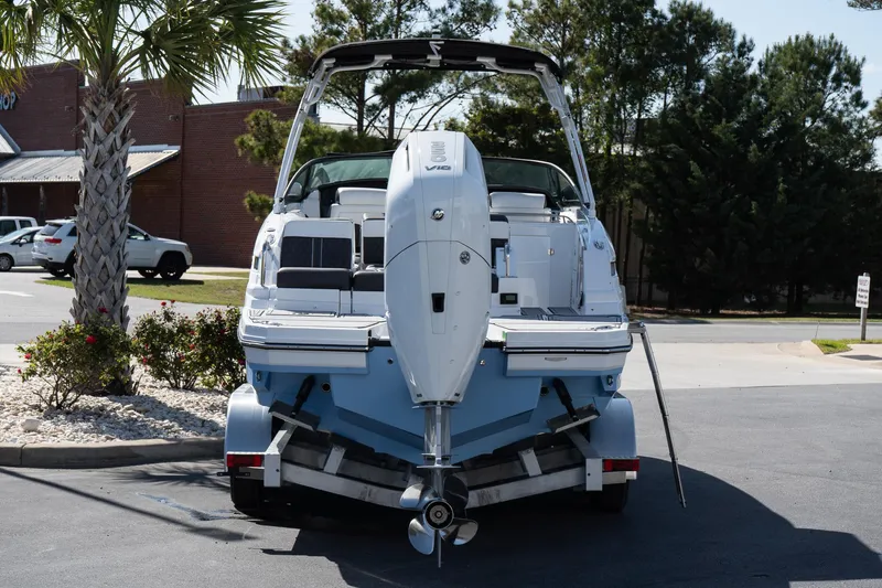 Slide: The Image of 2025 Monterey M-65 boat on trailer, rear view, parked outdoors. - 6