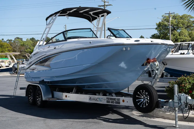 Slide: The Image of 2025 Monterey M-65 boat on trailer, sleek design, parked outdoors. - 7