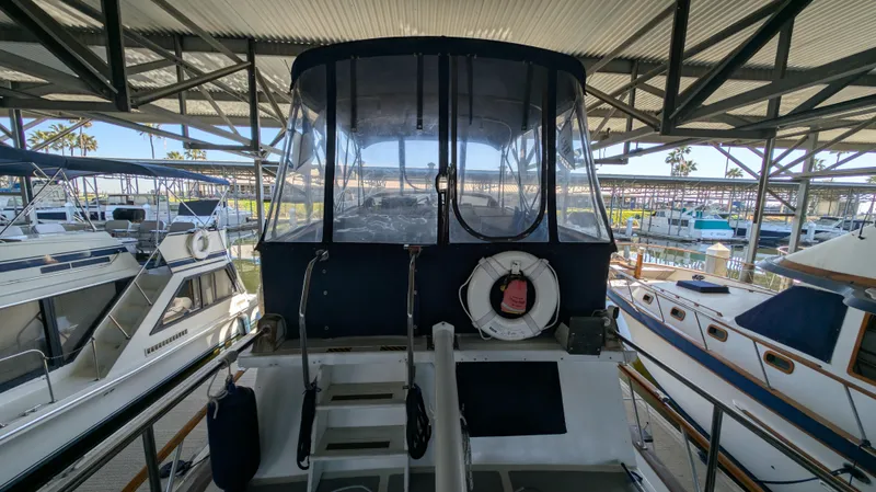 Slide: The Image of 1982 Monk 36 yacht docked in a marina, surrounded by other boats. - 11