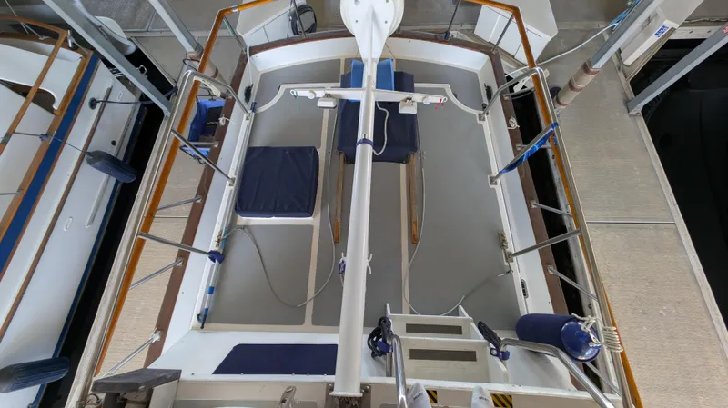 Slide: The Image of 1982 Monk 36 boat interior with seating and equipment in a docked position. - 13