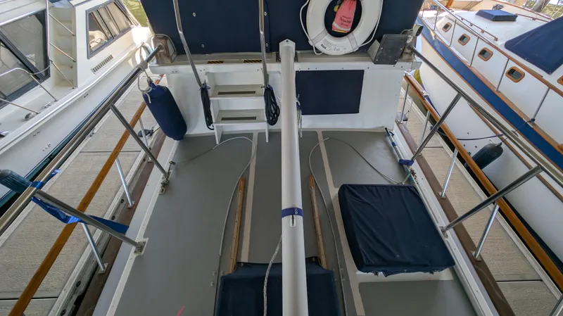 Slide: The Image of 1982 Monk 36 boat deck with seating, life preserver, and railing. - 15