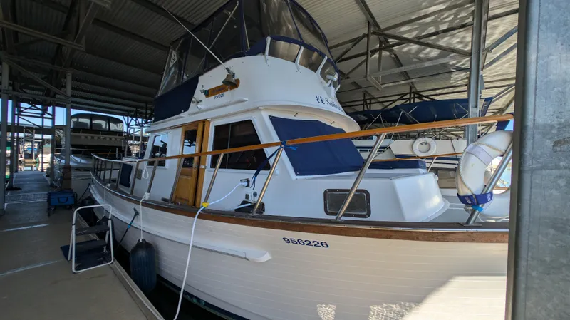 Slide: The Image of 1982 Monk 36 boat docked in a covered marina. - 2