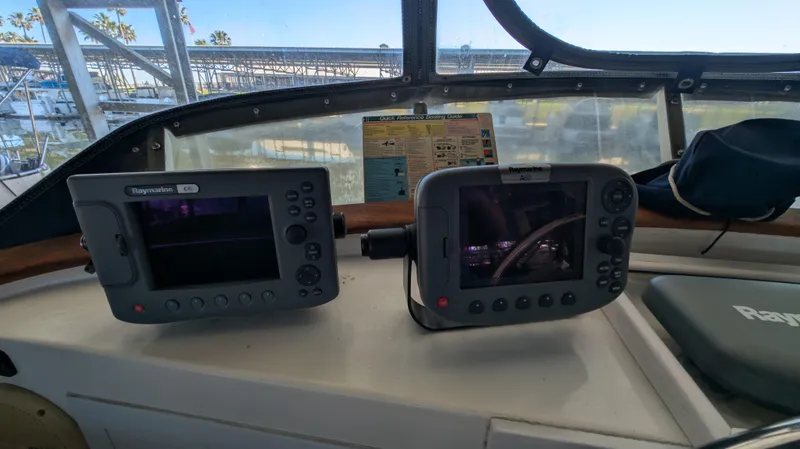 Slide: The Image of Boat cockpit with navigation equipment, featuring Raymarine displays on a 1982 Monk 36 model. - 20