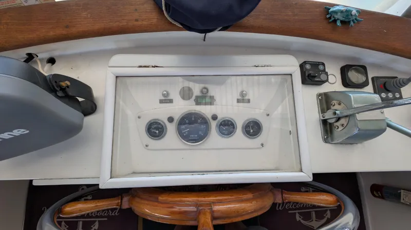 Slide: The Image of 1982 Monk 36 boat dashboard with gauges, steering wheel, and controls. - 21
