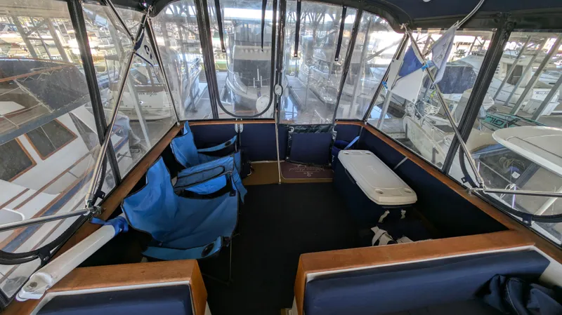 Slide: The Image of Enclosed deck area of a 1982 Monk 36 boat with seating and cooler. - 24