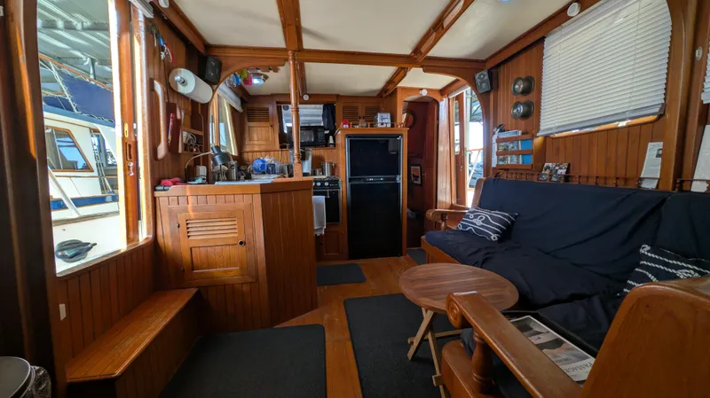 Slide: The Image of Interior of a 1982 Monk 36 boat with wooden furnishings and cozy seating area. - 28
