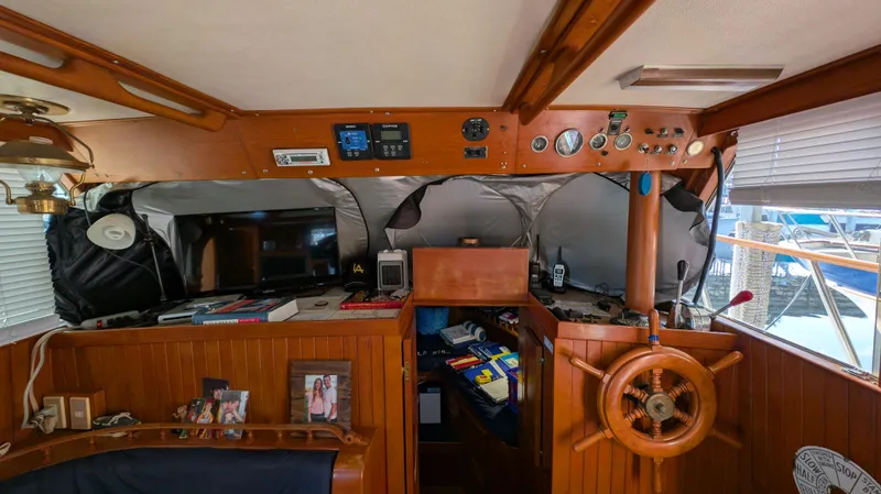 Slide: The Image of Interior of a 1982 Monk 36 boat with wooden helm and nautical instruments. - 31
