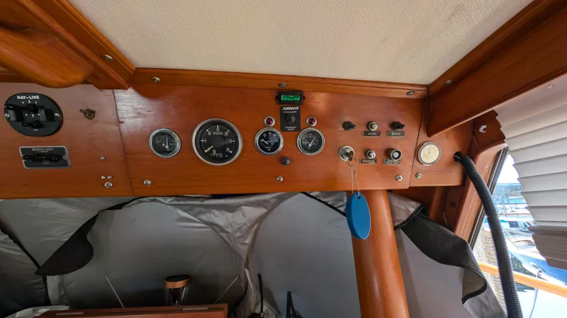 Slide: The Image of Control panel of a 1982 Monk 36 boat with gauges and switches. - 32