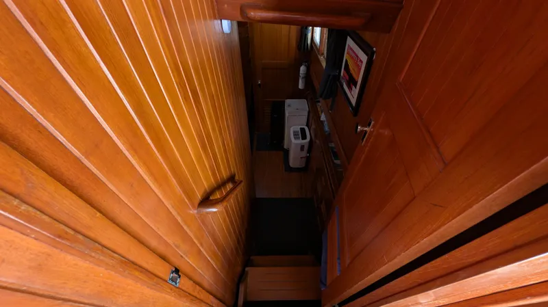 Slide: The Image of Wooden interior of 1982 Monk 36 boat, featuring stairs and hallway. - 34