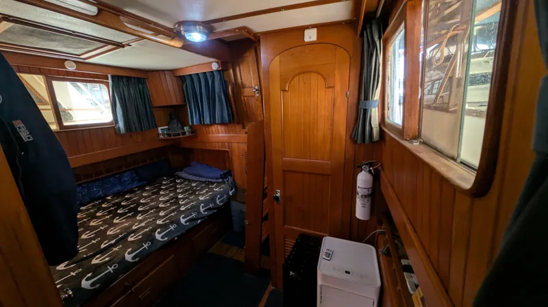 Slide: The Image of Cozy cabin interior of 1982 Monk 36 boat with wooden paneling and nautical decor. - 35