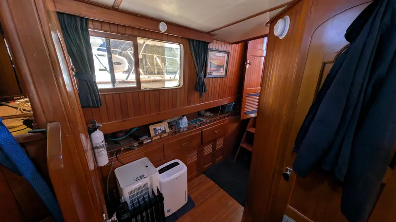 Slide: The Image of Interior of 1982 Monk 36 boat with wooden paneling and nautical decor. - 38