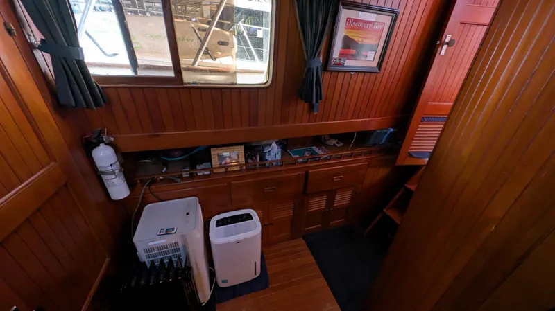 Slide: The Image of Interior of 1982 Monk 36 boat with wooden paneling and nautical decor. - 40