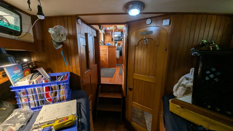 Slide: The Image of Interior of a 1982 Monk 36 boat with wooden paneling and storage areas. - 47