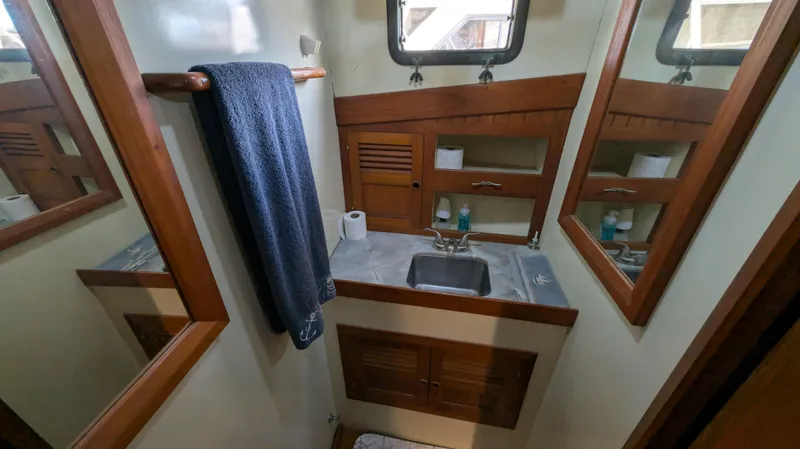 Slide: The Image of Compact bathroom in 1982 Monk 36 boat with wooden cabinets and mirrors. - 49