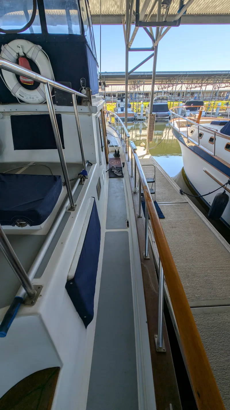 Slide: The Image of 1982 Monk 36 boat docked in marina, side view with life preserver. - 9