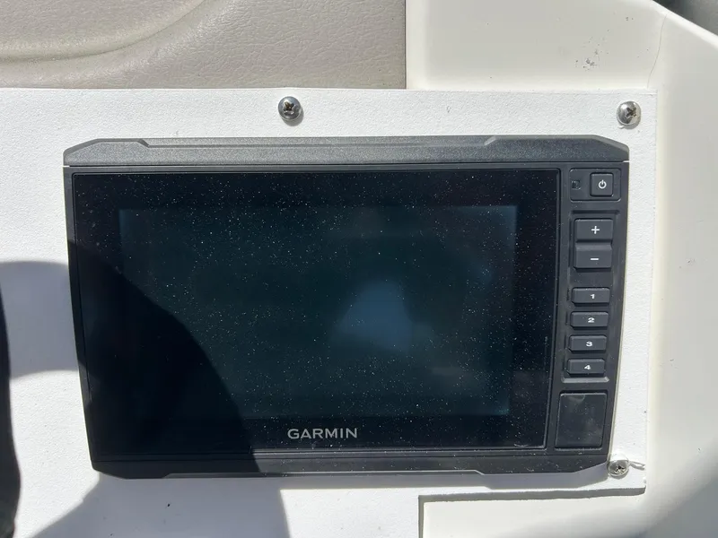 Slide: The Image of Garmin navigation system on a 2003 Stingray 240 LR boat dashboard. - 12