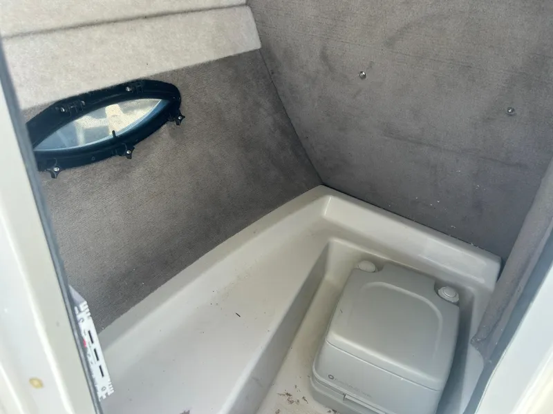 Slide: The Image of Interior cabin of a 2003 Stingray 240 LR boat with a portable toilet. - 27