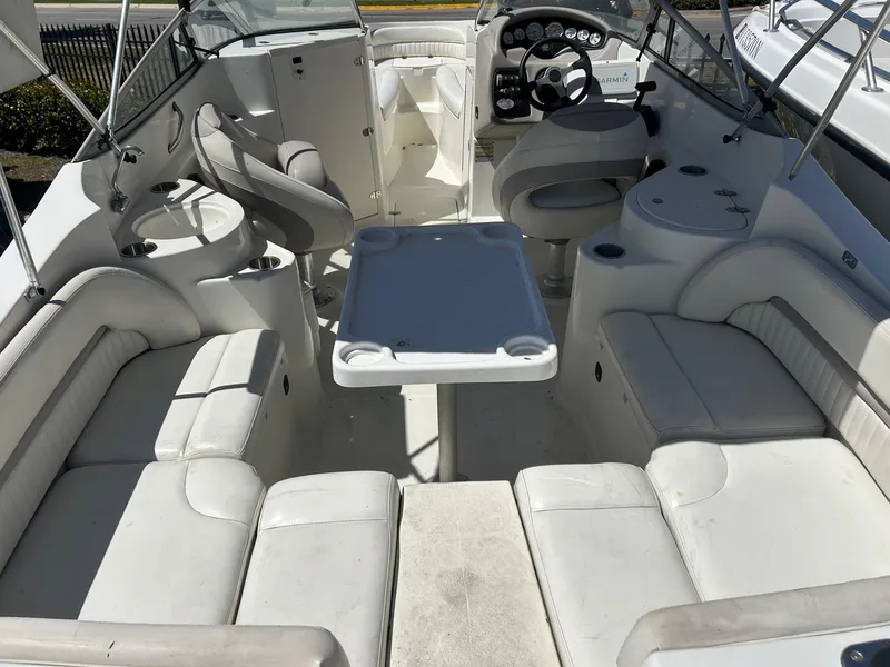 Slide: The Image of 2003 Stingray 240 LR boat interior with white seating and steering console. - 4