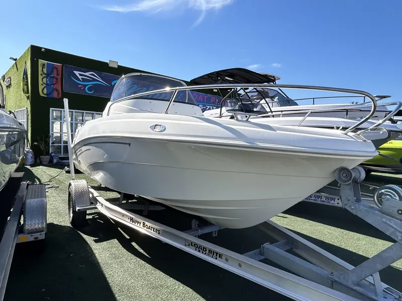 Slide: The Image of 2022 Hussar AM-555 boat on trailer, displayed outdoors under clear blue sky. - 1
