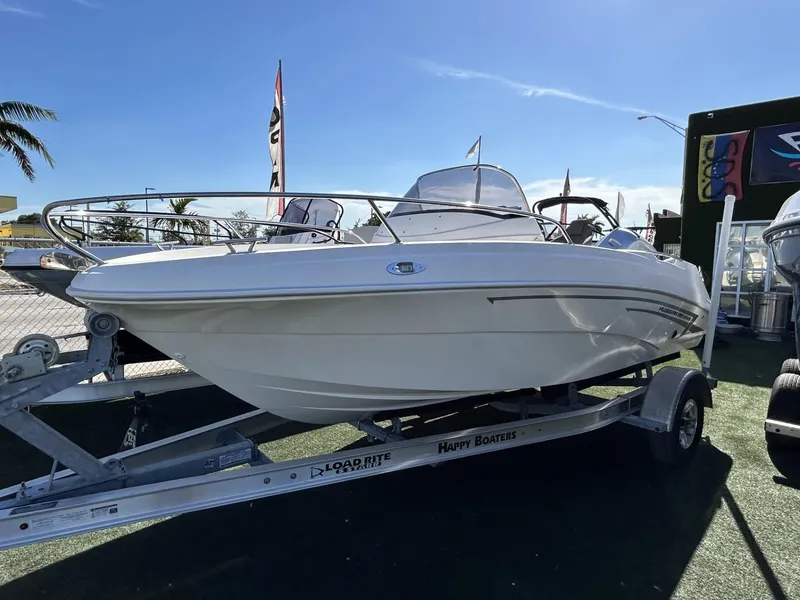 Slide: The Image of 2022 Hussar AM-555 boat on trailer under clear blue sky. - 2