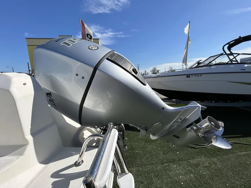 Slide: The Image of Outboard motor on a Hussar AM-555 boat, 2022 model, under clear blue sky. - 5