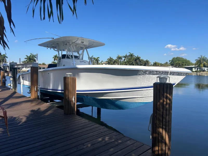 The Image of 2002 Venture 34 Center Console boat docked on a sunny day. - 0
