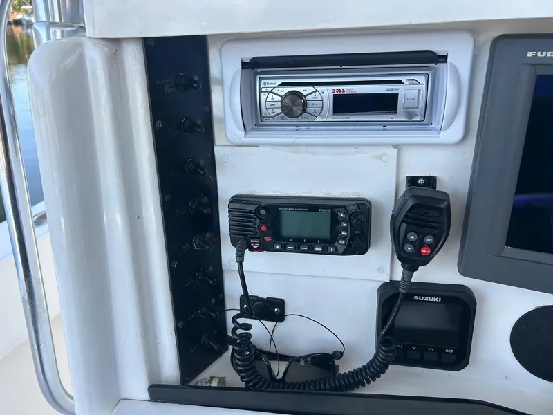 Slide: The Image of 2002 Venture 34 Center Console dashboard with radio and communication equipment. - 12