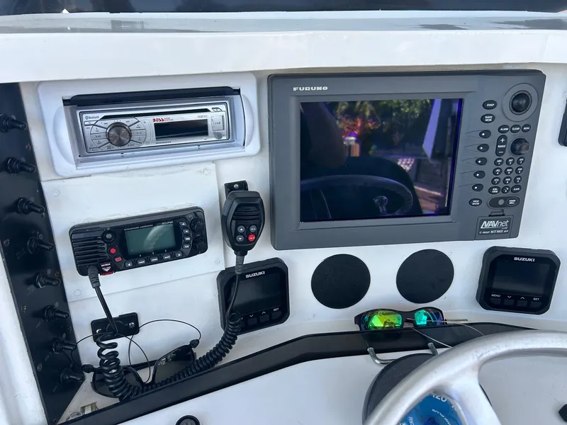 Slide: The Image of 2002 Venture 34 Center Console dashboard with navigation and communication equipment. - 13